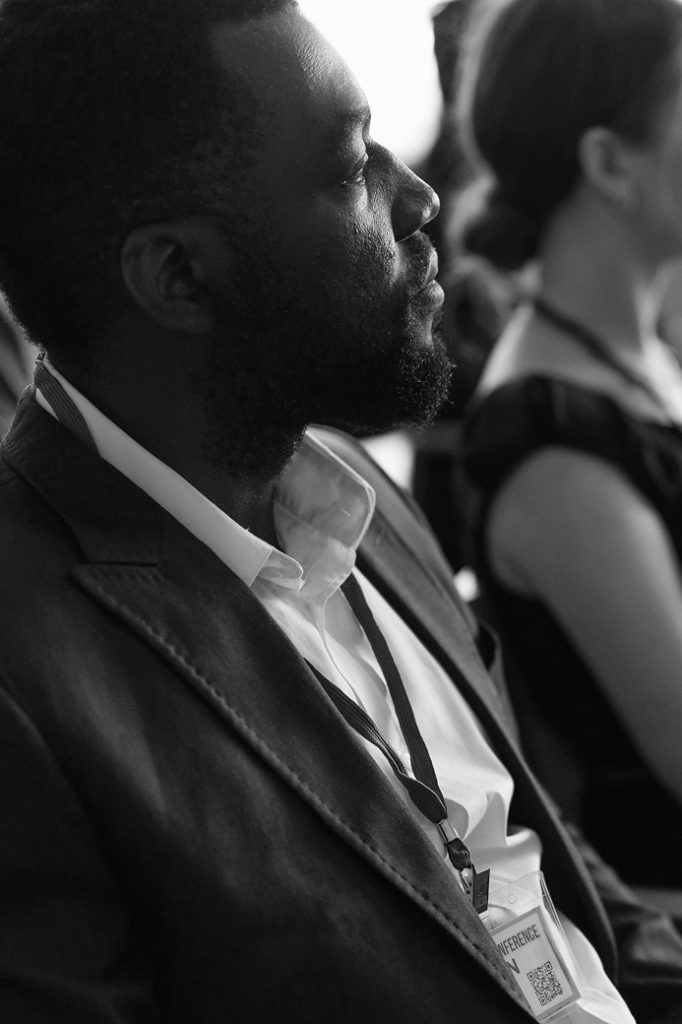 A minister listening during a conference session